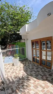 a house with a gate and a patio with a plant at Boquilla Cozy Spot Live Like a Local in Cartagena de Indias