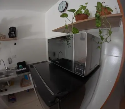 a microwave sitting on a counter in a kitchen at Boquilla Cozy Spot Live Like a Local in Cartagena de Indias