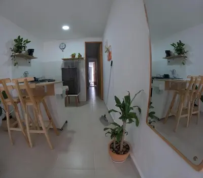 a living room with a table and chairs and a mirror at Boquilla Cozy Spot Live Like a Local in Cartagena de Indias