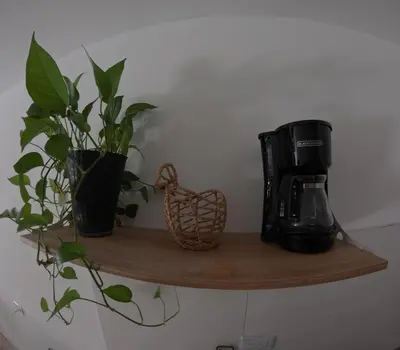 a wooden shelf with a coffee maker and a plant at Boquilla Cozy Spot Live Like a Local in Cartagena de Indias