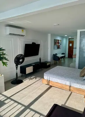 a bedroom with a bed and a living room at leslies apartamentos in Cartagena de Indias