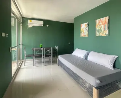 a bedroom with a bed and a table with chairs at Sea view apartment in Cartagena de Indias