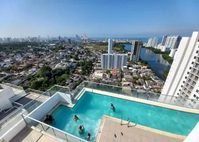 a swimming pool on top of a building with a city at Sea view apartment in Cartagena de Indias