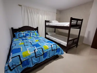 a bedroom with a bed and a bunk bed at Casa Hotel Luisa in Cartagena de Indias
