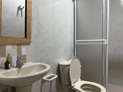 a bathroom with a toilet and a sink at Casa Hotel Luisa in Cartagena de Indias