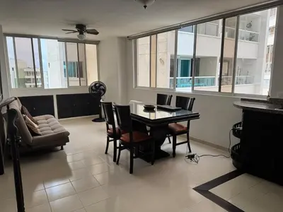 a living room with a table and chairs and a couch at Laguito Beach Cartagena in Cartagena de Indias