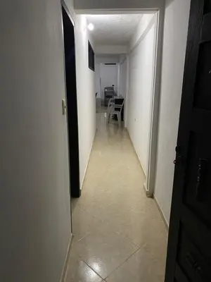 a long hallway with a white door and a white wall at Apartamento Goyo en Coveñas in Coveñas