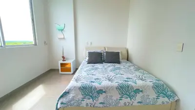 a bedroom with a bed in a white room at Magico Apartamento Frente al Mar 4 Habitaciones CB72 in Estación El Salto