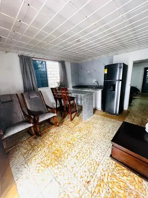 a kitchen with chairs and a table and a refrigerator at Lilis house in Cartagena de Indias