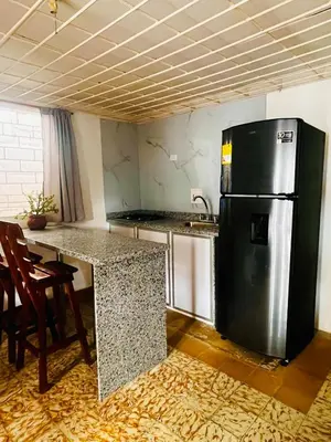 a kitchen with a stainless steel refrigerator and a table at Lilis house in Cartagena de Indias