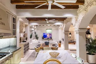 a kitchen and living room with a ceiling fan at IsaLuna Luxury House in Cartagena de Indias