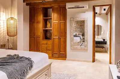 a bedroom with a bed and a mirror at IsaLuna Luxury House in Cartagena de Indias