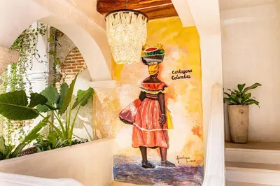 a painting of a woman with a basket on her head at IsaLuna Luxury House in Cartagena de Indias