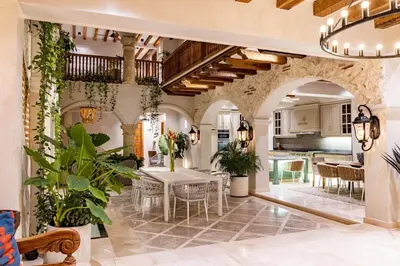 a kitchen and living room with a table and chairs at IsaLuna Luxury House in Cartagena de Indias