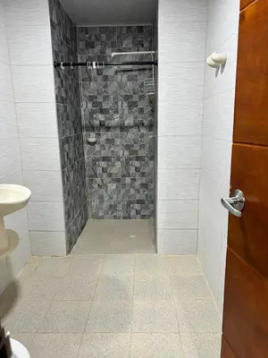 a bathroom with a shower with a stone wall at Villa Lexis in Coveñitas