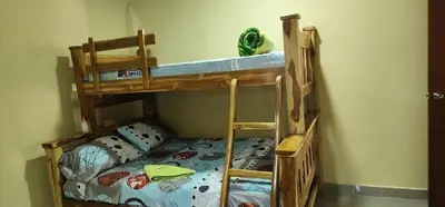 two bunk beds in a room with a bed at Villa Lexis in Coveñitas