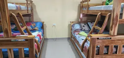 a room with three bunk beds and a couch at Villa Lexis in Coveñitas