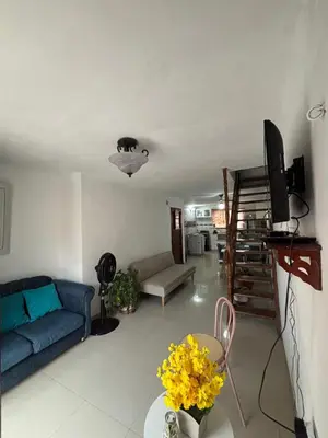 a living room with a blue couch and a tv at Ritze's House Getsemani in Cartagena de Indias