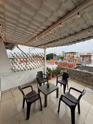 a patio with chairs and a table on a roof at Ritze's House Getsemani in Cartagena de Indias