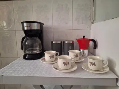 a counter with four cups and a coffee maker at Ritze's House Getsemani in Cartagena de Indias