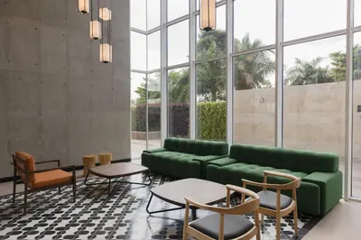 a living room with a green couch and chairs at Faranda Collection Cartagena, a member of Radisson Individuals in Cartagena de Indias