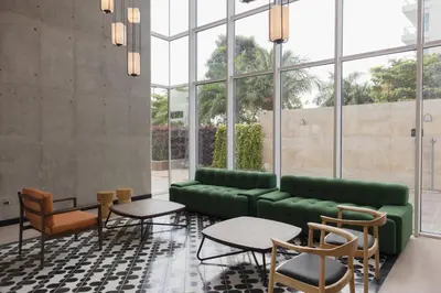 a living room with a green couch and chairs at Faranda Collection Cartagena, a member of Radisson Individuals in Cartagena de Indias