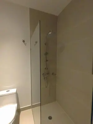 a bathroom with a glass shower with a toilet at Baia Kristal Kabo Apartamento in Cartagena de Indias