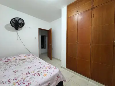 a bedroom with a bed and a large wooden cabinet at Un lugar cómodo y acogedor in Barranquilla