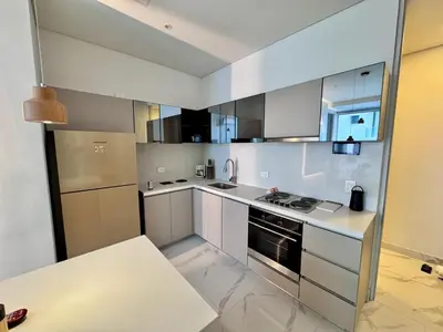 a kitchen with white cabinets and a stove at Santa marta bello horizonte Swift Lotf in Playa Bello Horizonte