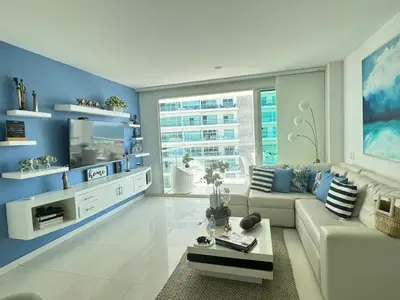 a living room with a white couch and blue walls at Luxurious apartment in Morros 3 in Cartagena de Indias