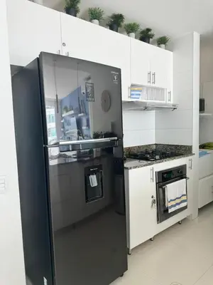 a kitchen with a black refrigerator and a stove at Luxurious apartment in Morros 3 in Cartagena de Indias