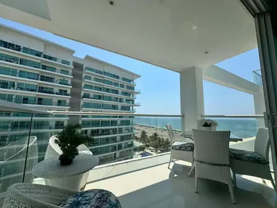 a balcony with chairs and a view of a building at Luxurious apartment in Morros 3 in Cartagena de Indias