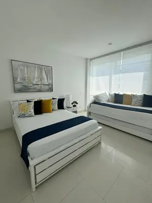 a bedroom with two beds and a large window at Luxurious apartment in Morros 3 in Cartagena de Indias