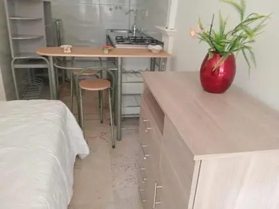 a kitchen with a desk and a table with a vase at apartaestudio ideal manga in Cartagena de Indias