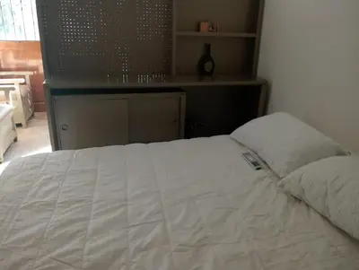 a bed in a bedroom with a white bedspread at apartaestudio ideal manga in Cartagena de Indias