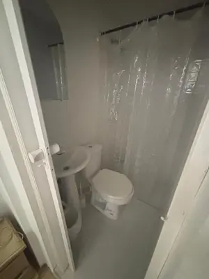 a white bathroom with a toilet and a sink at apartaestudio ideal manga in Cartagena de Indias