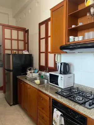 a kitchen with a microwave and a stove top oven at Loft in Old Town, Cartagena in Cartagena de Indias