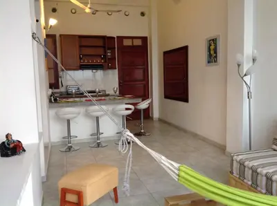 a hammock in a living room with a kitchen at Loft in Old Town, Cartagena in Cartagena de Indias