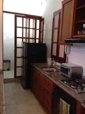 a kitchen with a stove and a sink and a refrigerator at Loft in Old Town, Cartagena in Cartagena de Indias