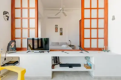 a room with a desk with a tv and a bed at Loft in Old Town, Cartagena in Cartagena de Indias