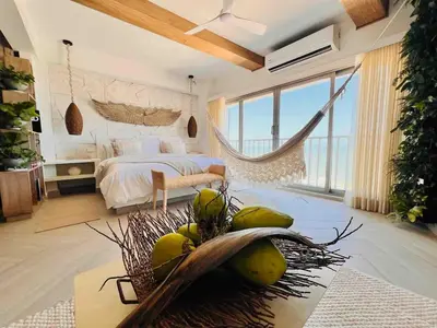 a bedroom with a bed with a bunch of fruit on the floor at Casa Manalva ocean view penthouse in walled city in Cartagena de Indias