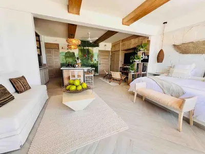 a bedroom with a bed and a table with a bowl of fruit at Casa Manalva ocean view penthouse in walled city in Cartagena de Indias
