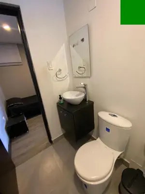 a bathroom with a white toilet and a sink at Apto Torre Centauro, El Laguito in Cartagena de Indias