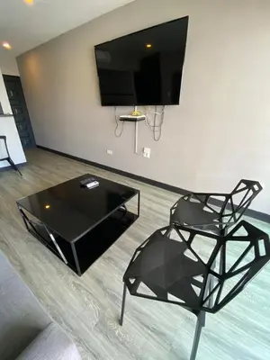 a black glass coffee table in a living room at Apto Torre Centauro, El Laguito in Cartagena de Indias