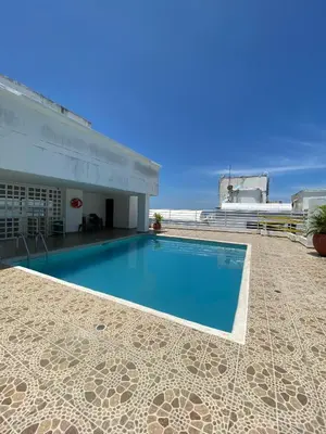 a swimming pool on the side of a building at Apto Torre Centauro, El Laguito in Cartagena de Indias