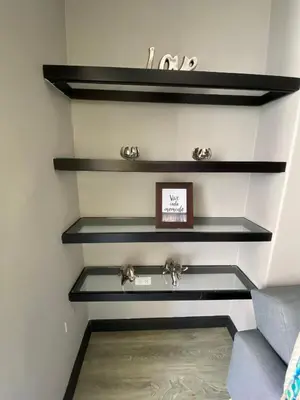 a staircase with black shelves in a room at Apto Torre Centauro, El Laguito in Cartagena de Indias