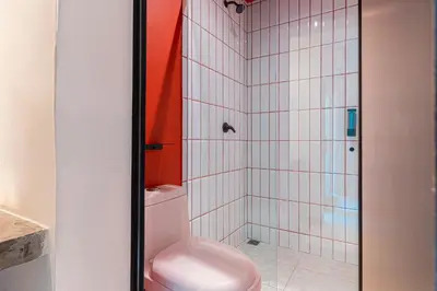 a bathroom with a toilet and a shower at Casa Stella Rooms in Cartagena de Indias