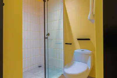a bathroom with a toilet and a shower at Casa Stella Rooms in Cartagena de Indias