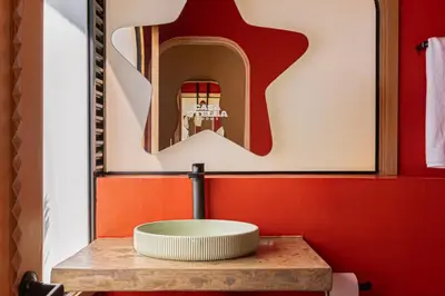 a bathroom with a sink and a wooden table at Casa Stella Rooms in Cartagena de Indias