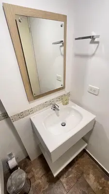 a bathroom with a white sink and a mirror at Cabrero Beach 507 in Cartagena de Indias